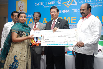 Mr R K Dubey, Chairman & Managing Director of Canara Bank, handing over cheque to the education loan beneficiary, flanked by Mr G V Manimaran, Director of the Bank and Mr R M Meenakshi Sundaram, General Manager, Chennai Circle  