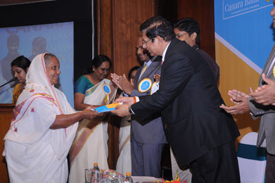 Canara Bank Chairman and Managing Director, Mr R K Dubey, handing over a passbook to a customer who opened the first account in Kiosk bank in Trivandrum